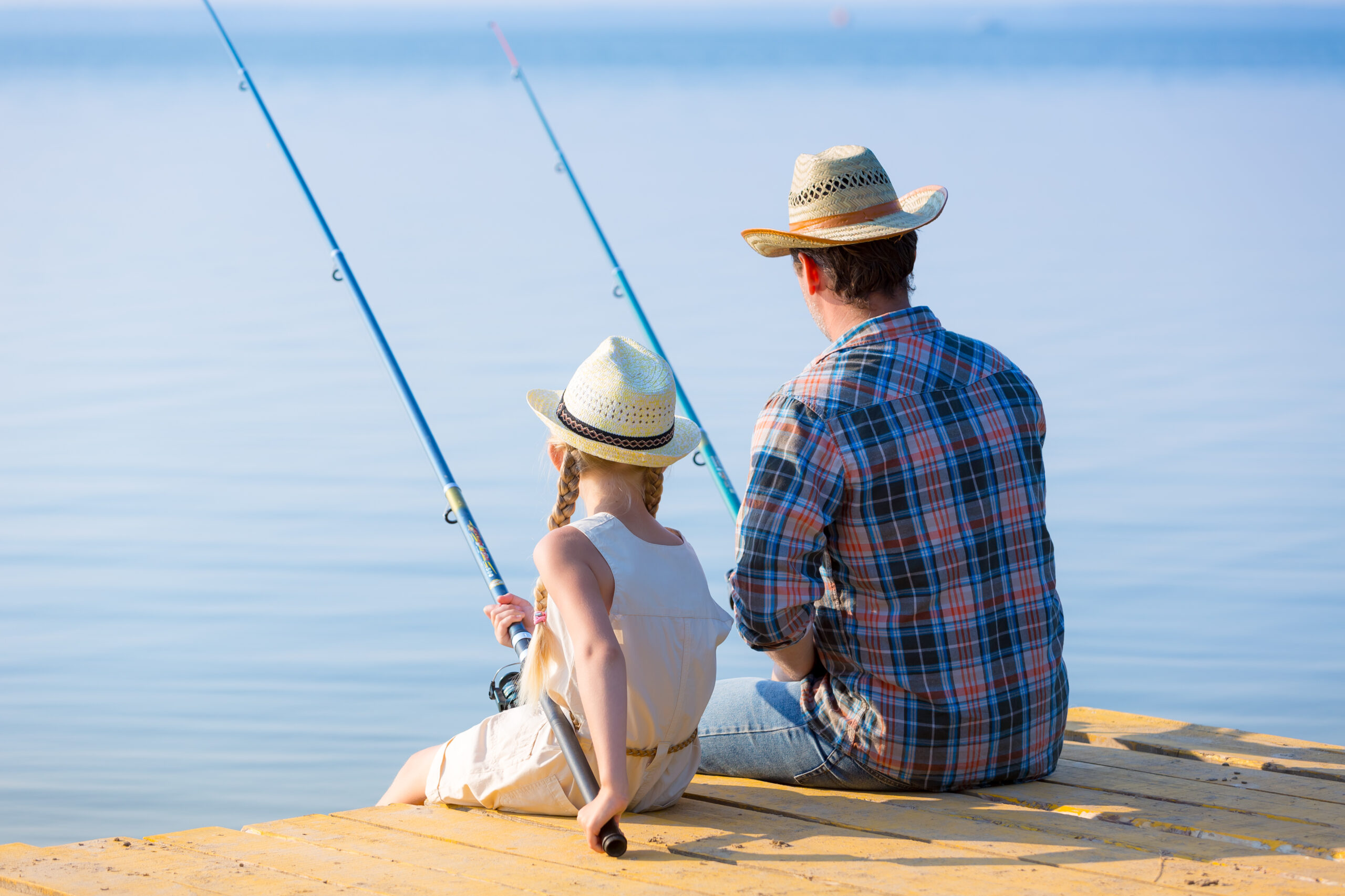 Father and daughter fishing on the pier